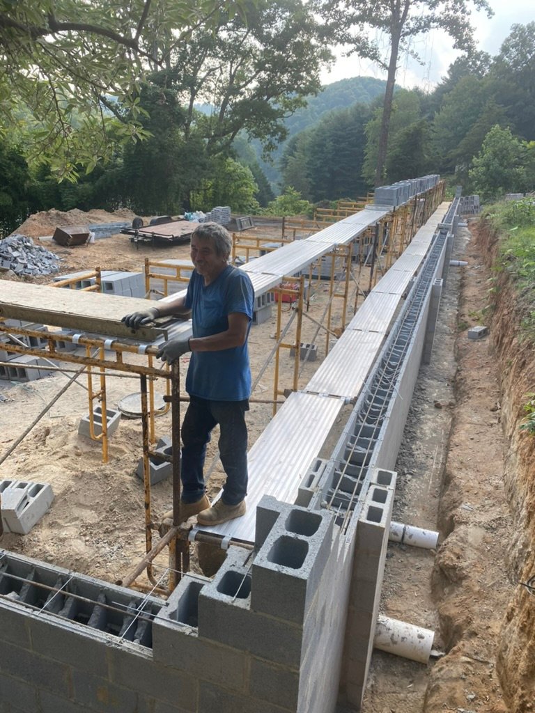 Masonry crew at work — laying CMU block along the terrace perimeter